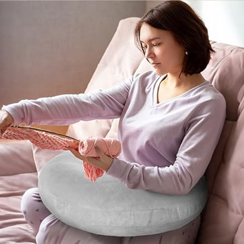 A mother uses the BodyLuxCare arm pillow to provide comfortable support while holding her baby.